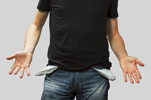 Man showing his empty pockets, no money