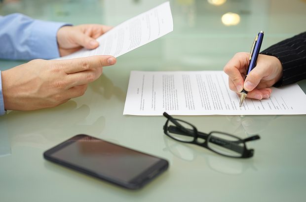 businessman and woman are reading and signing contract