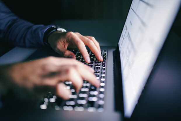 Person typing on a laptop