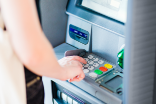 a bank customer at an atm machine